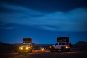 Two Jeep Wrangler JK's with roof rack tents camping out in the Moab desert. 