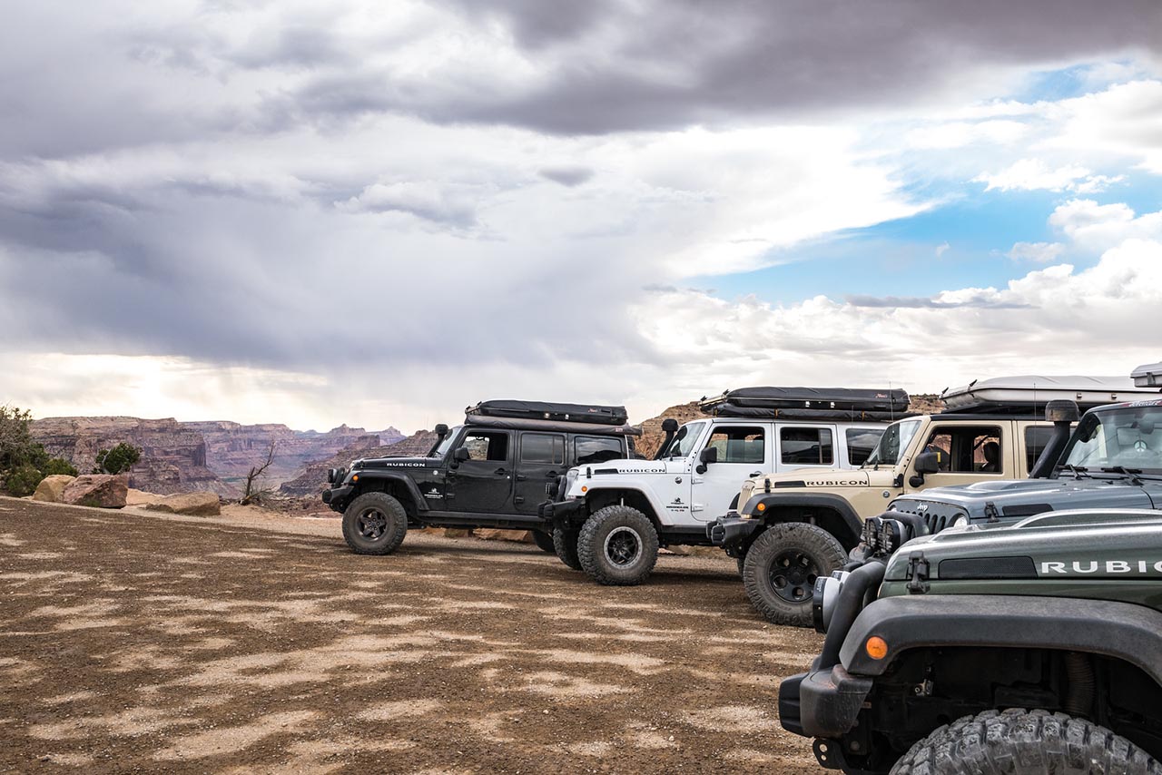 Three AEV Jeeps parked at a stop